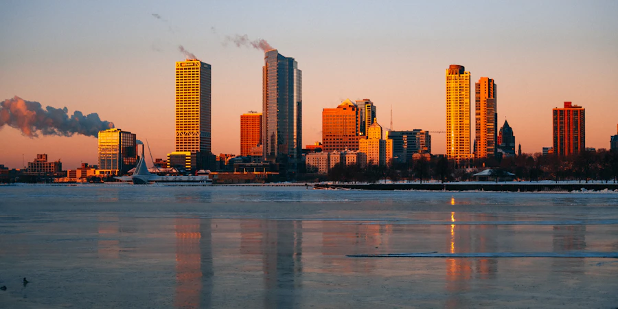 Milwaukee towers at sunrise over a frozen harbor
