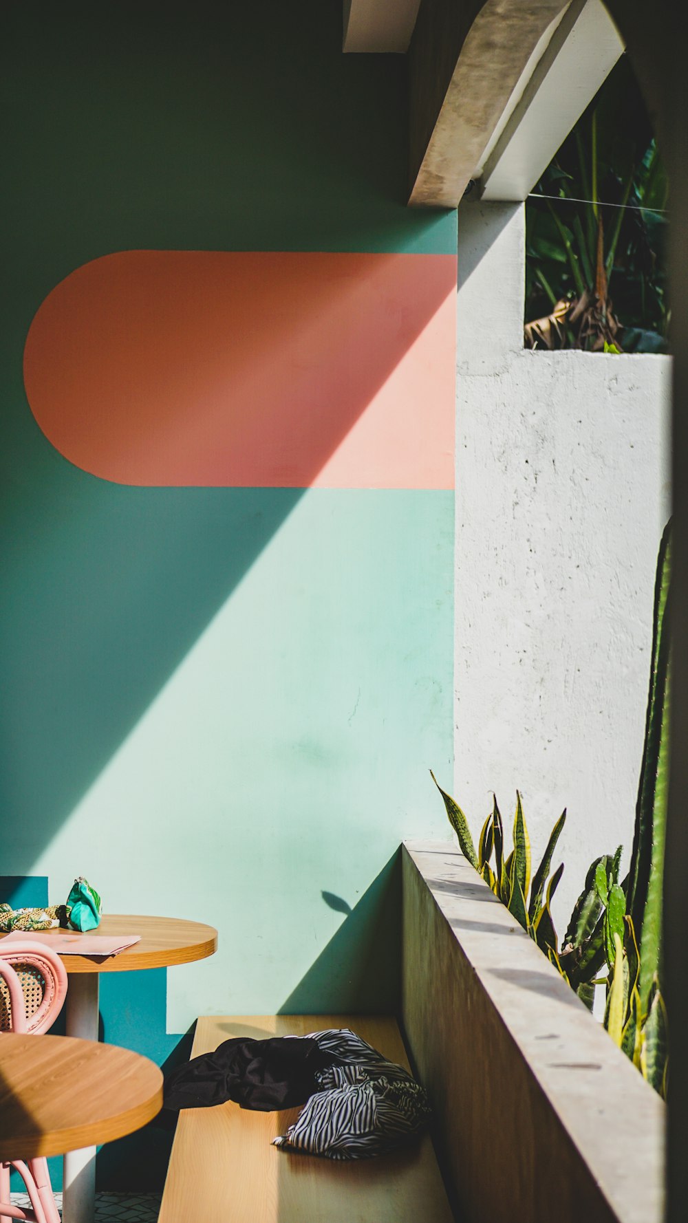 two black and gray apparels on concrete bench beside table