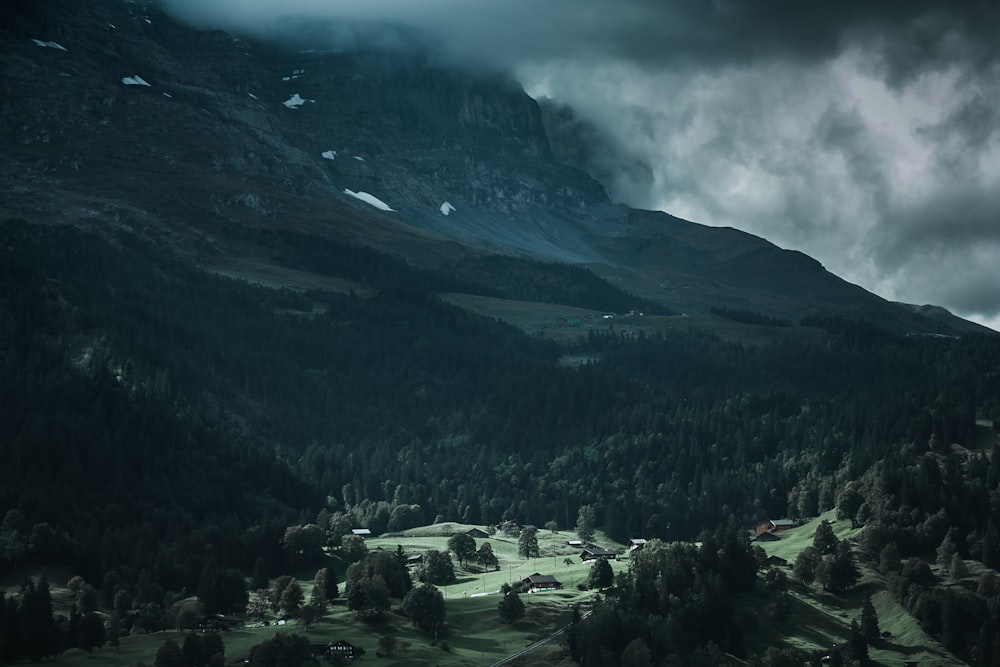 green mountain covered by gray clouds