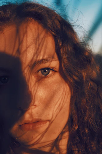 Close-up portrait highlighting natural beauty with artistic shadows.