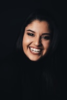 A smiling face illuminated by warm light, reflecting inner peace and positivity.