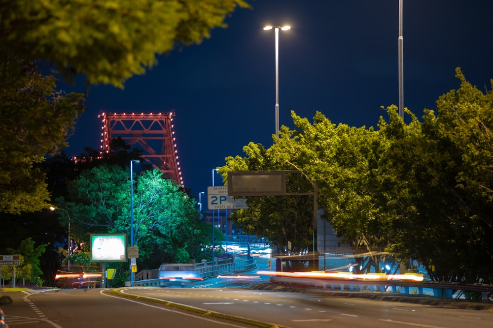 time-lapse photography of moving vehicle on road at night