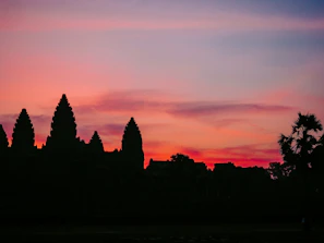Sunset over the Sacred Valley with ancient Inca ruins silhouetted against colorful skies.