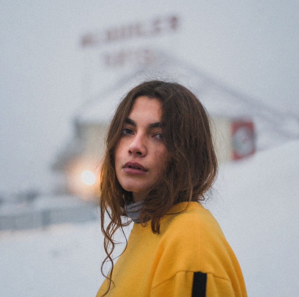 woman standing near white building