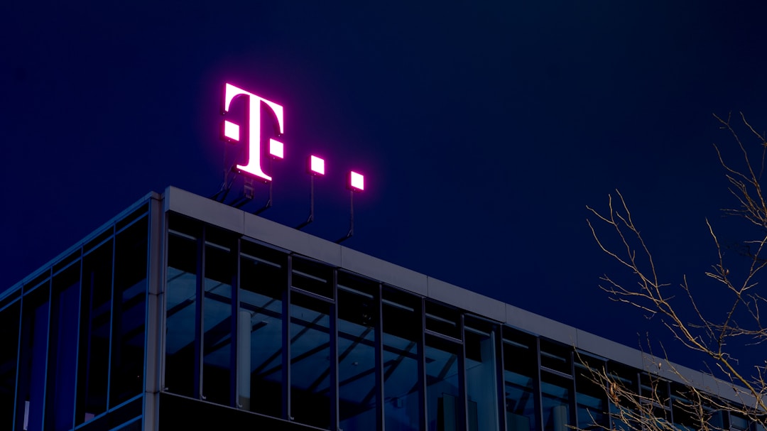 T-Mobile logo illuminated at night, symbolizing innovation in telecom and knowledge management