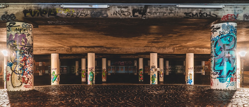 graffiti on white concrete columns