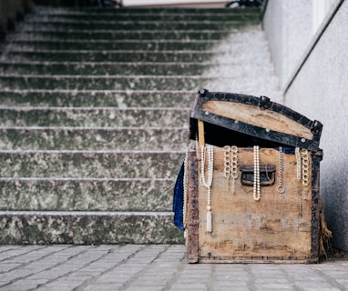 brown jewelry box beside concrete stairs