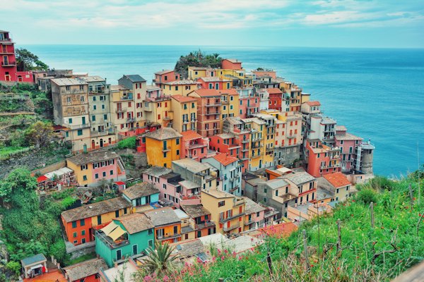 Multi-colored village on mountain near body of water — Cinque Terre, Italy
