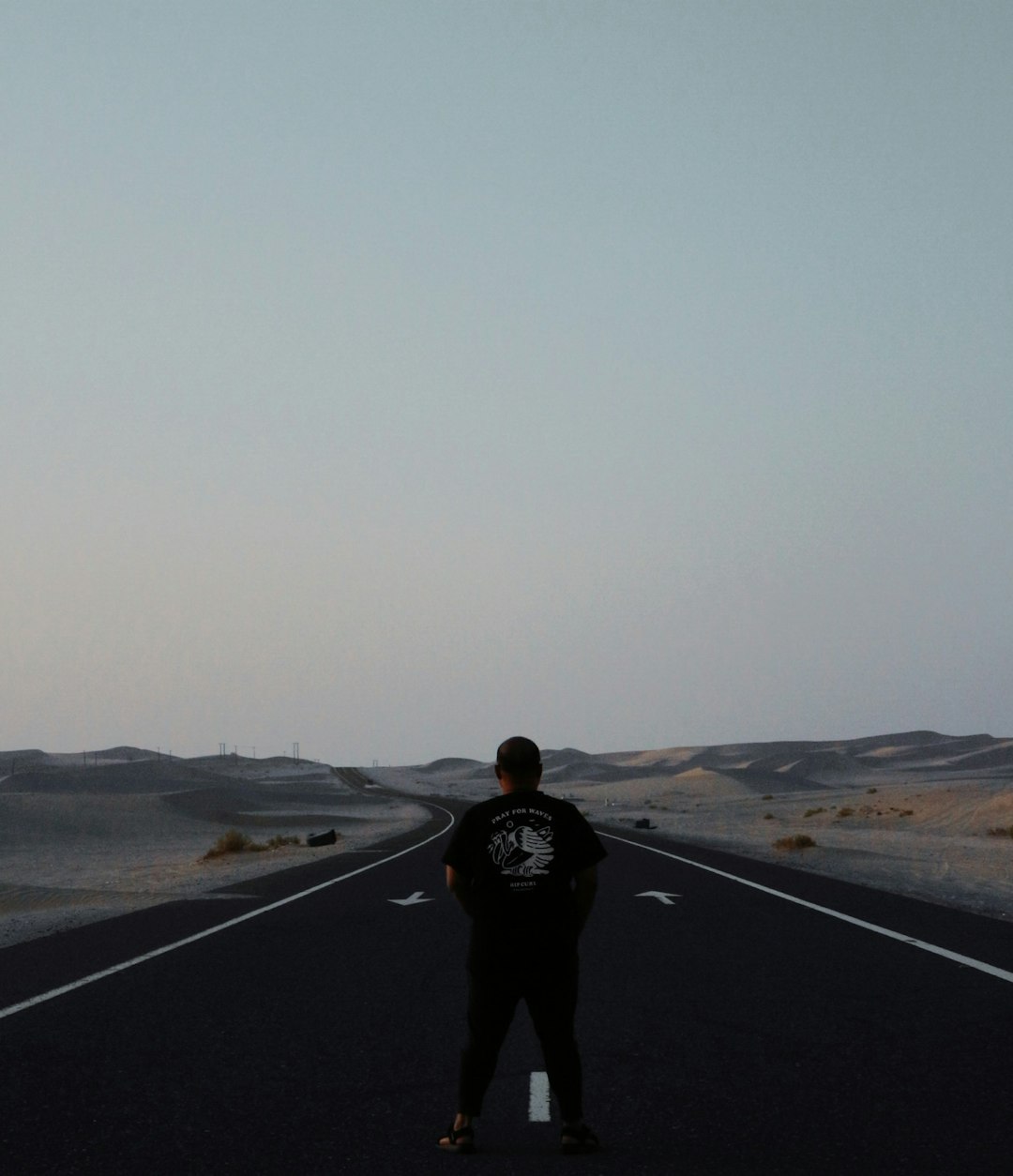 man standing on road