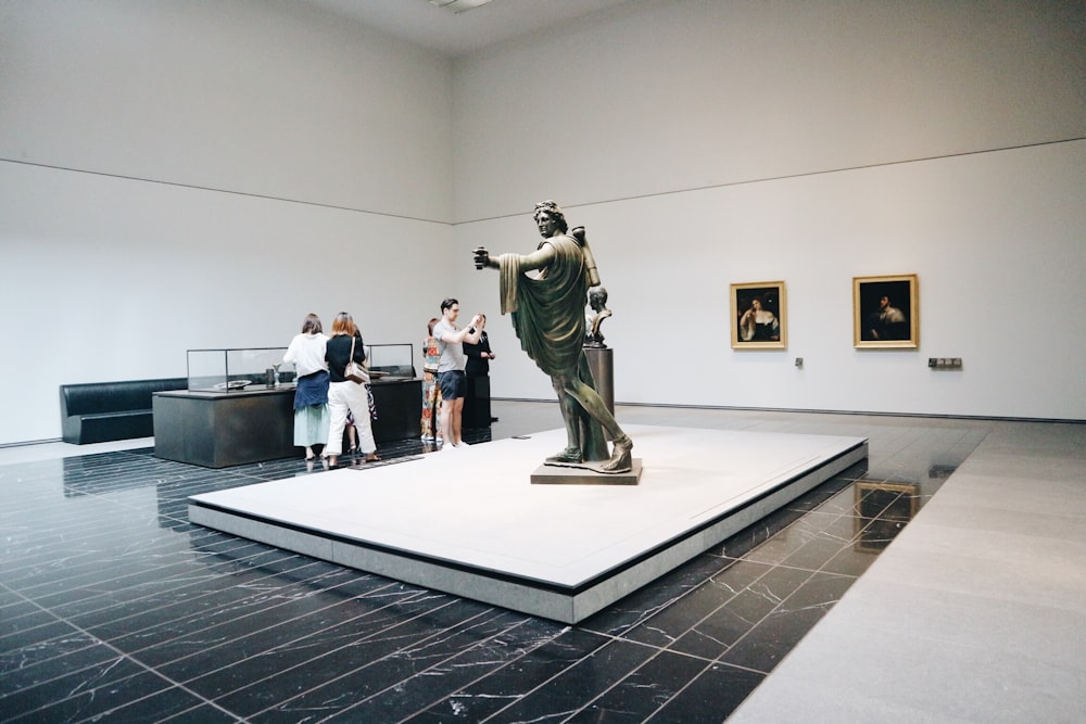 people standing near statue