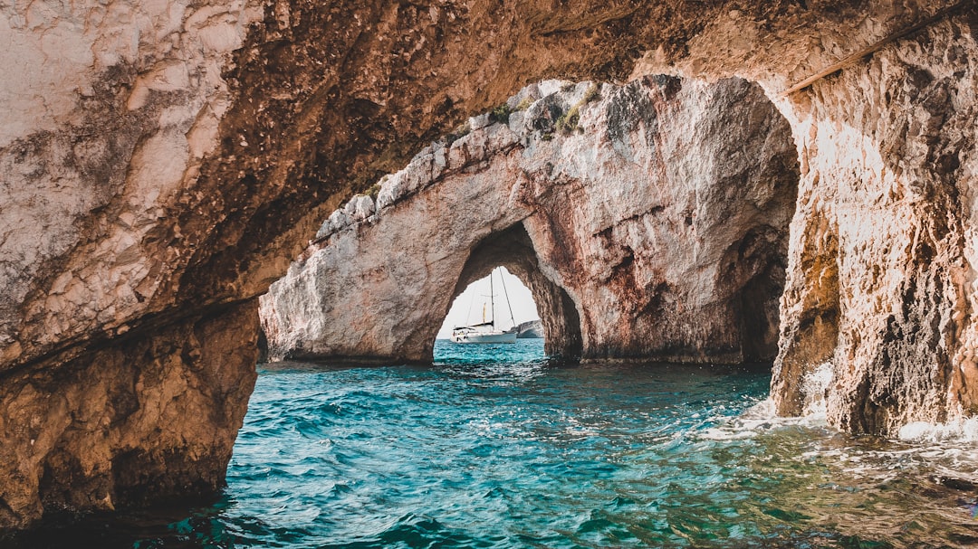 Just as we were peeking through Zakynthos’ blue caves, a boat aligned right through multiple caves.