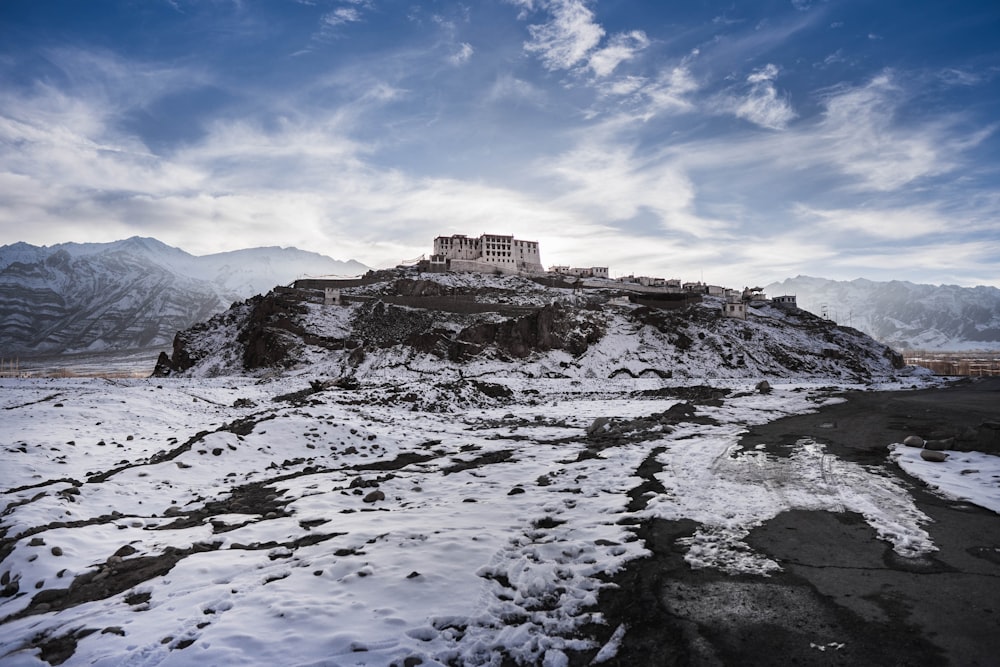 brown concrete building on top of mountain