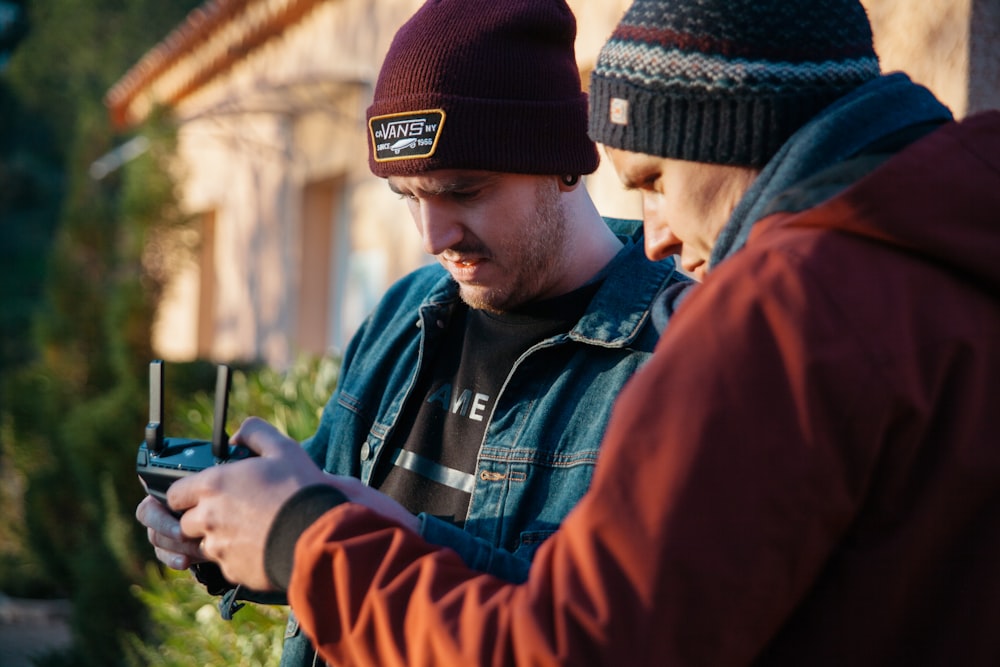 two men using black device