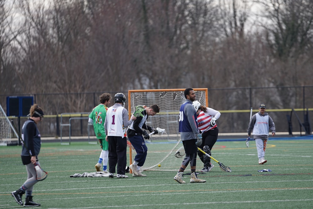 people playing sports game on field during daytime