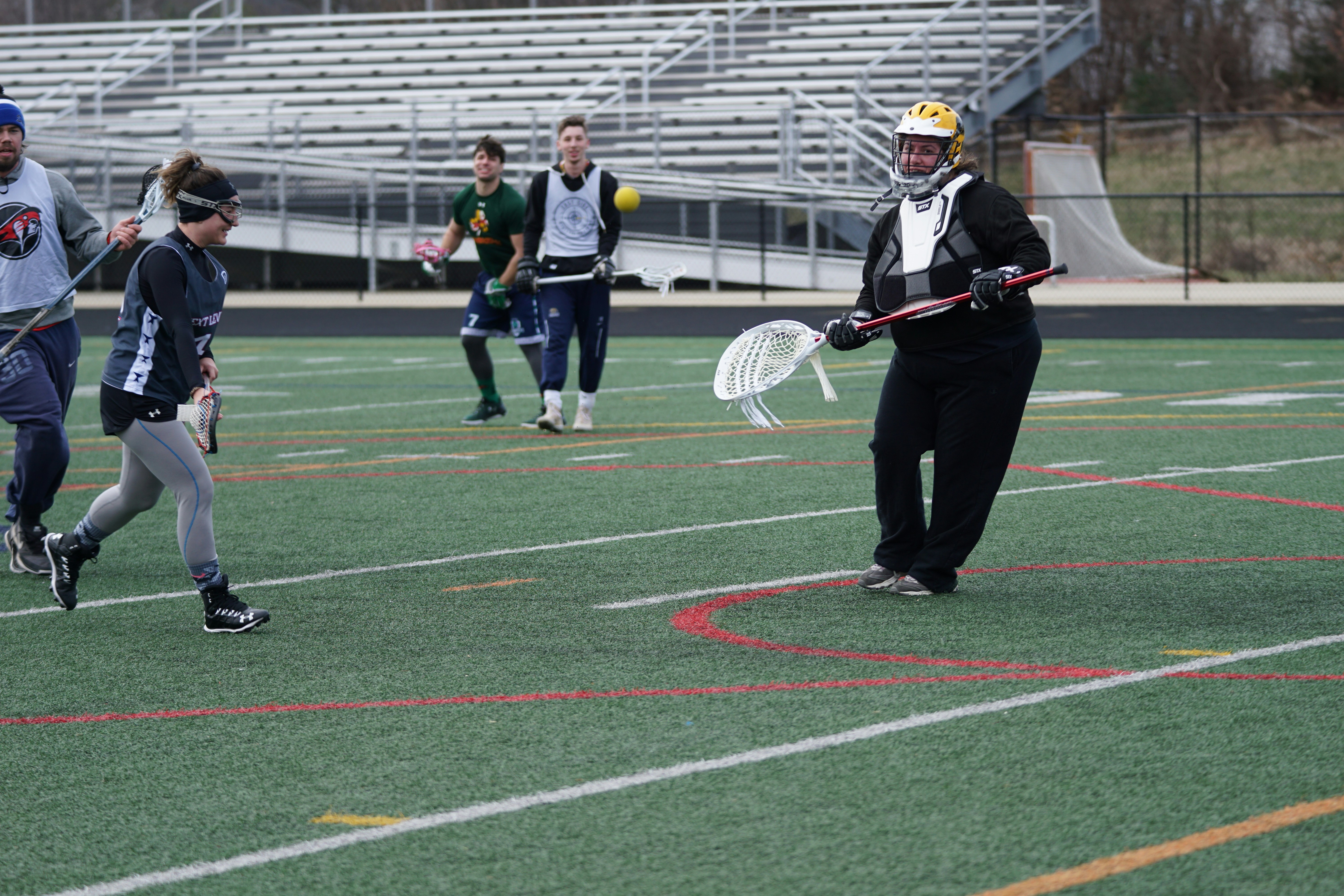 people playing lacrosse during daytime