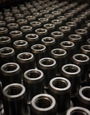 a large group of metal flanges sitting on top of a table