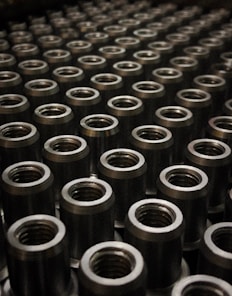 a large group of metal flanges sitting on top of a table