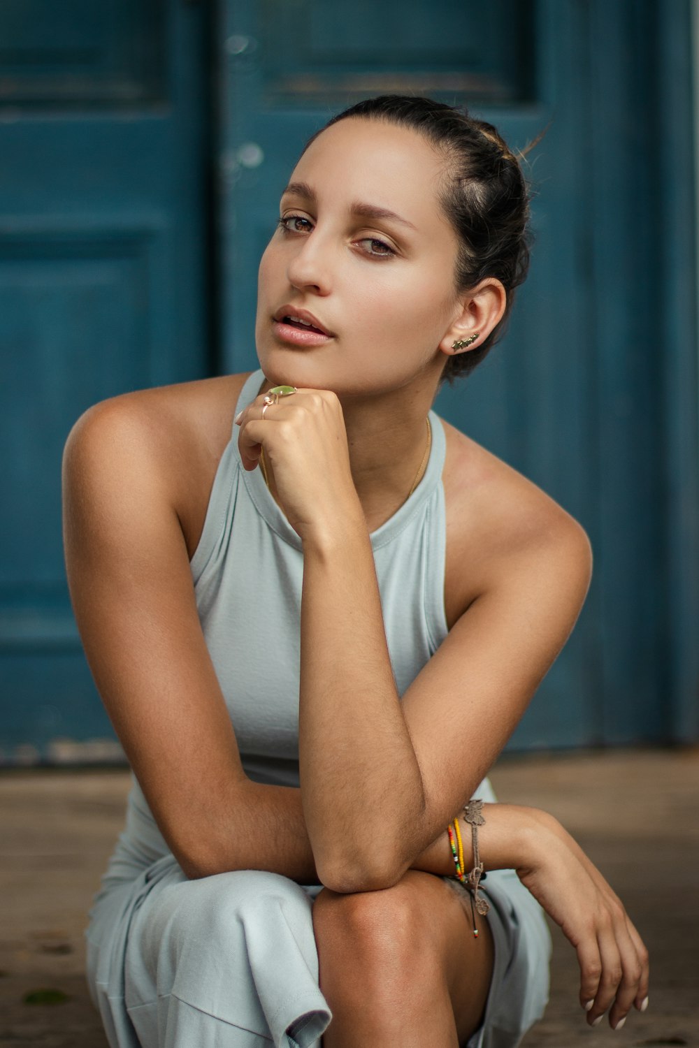 close-up photography of woman sitting front of door