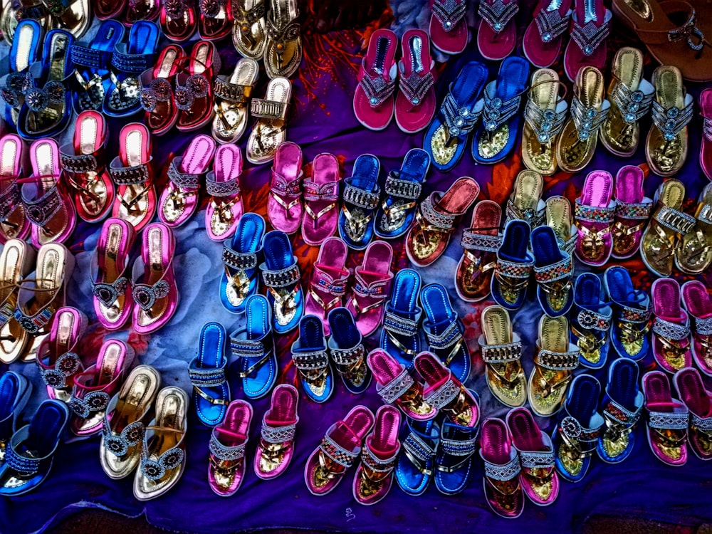 assorted-color sandal lot on blue textile
