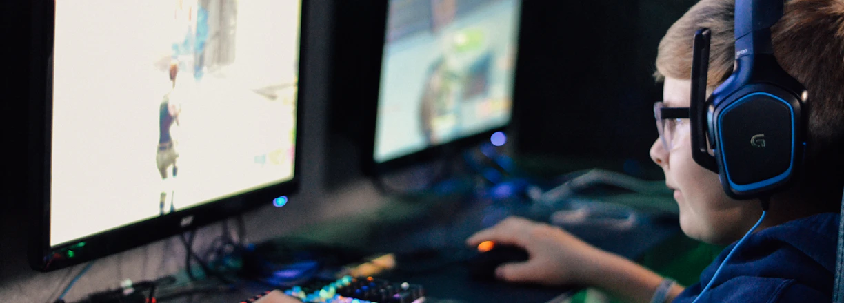 boy wearing headset playing computer game