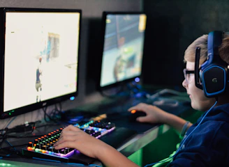 boy wearing headset playing computer game