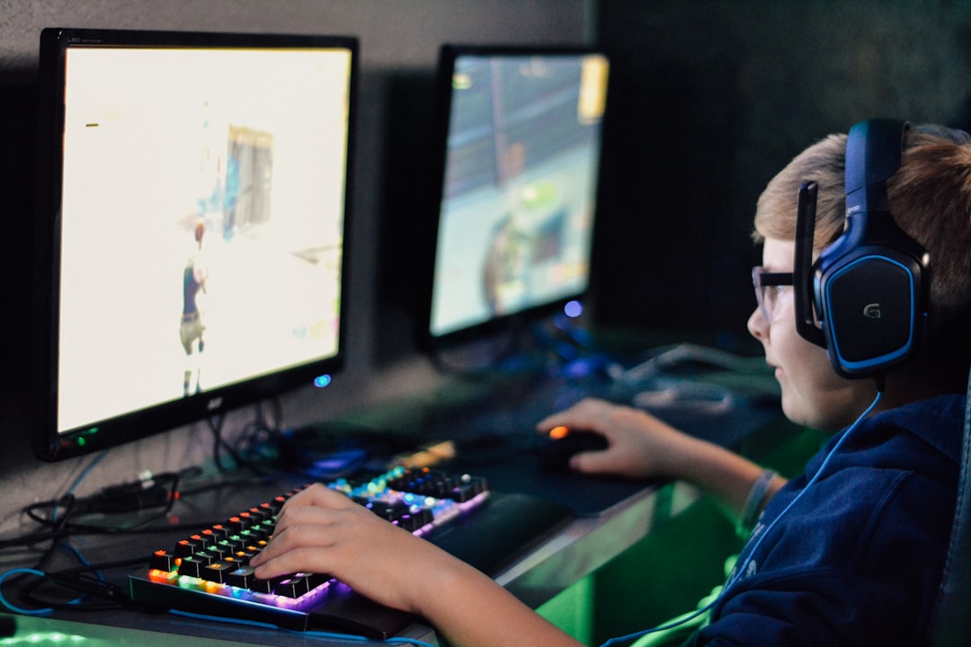 boy wearing headset playing computer game,