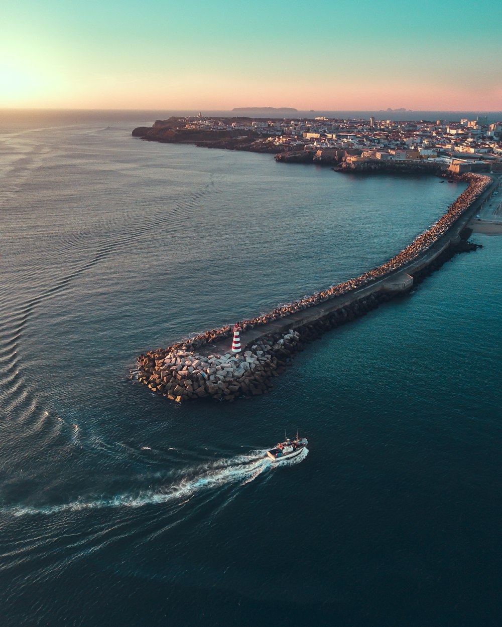 aerial photography of island and boat during daytime