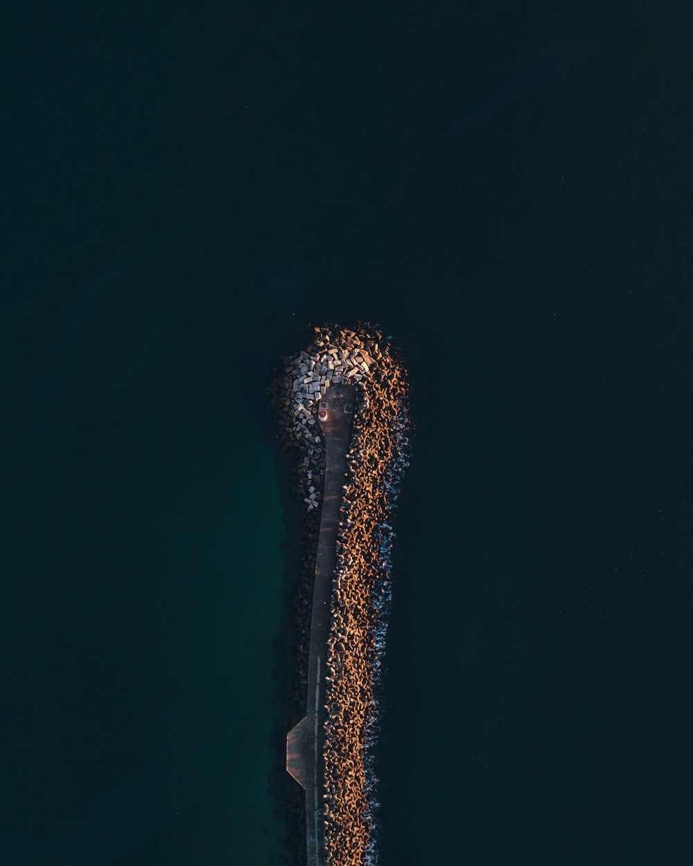 an aerial view of a boat in a body of water