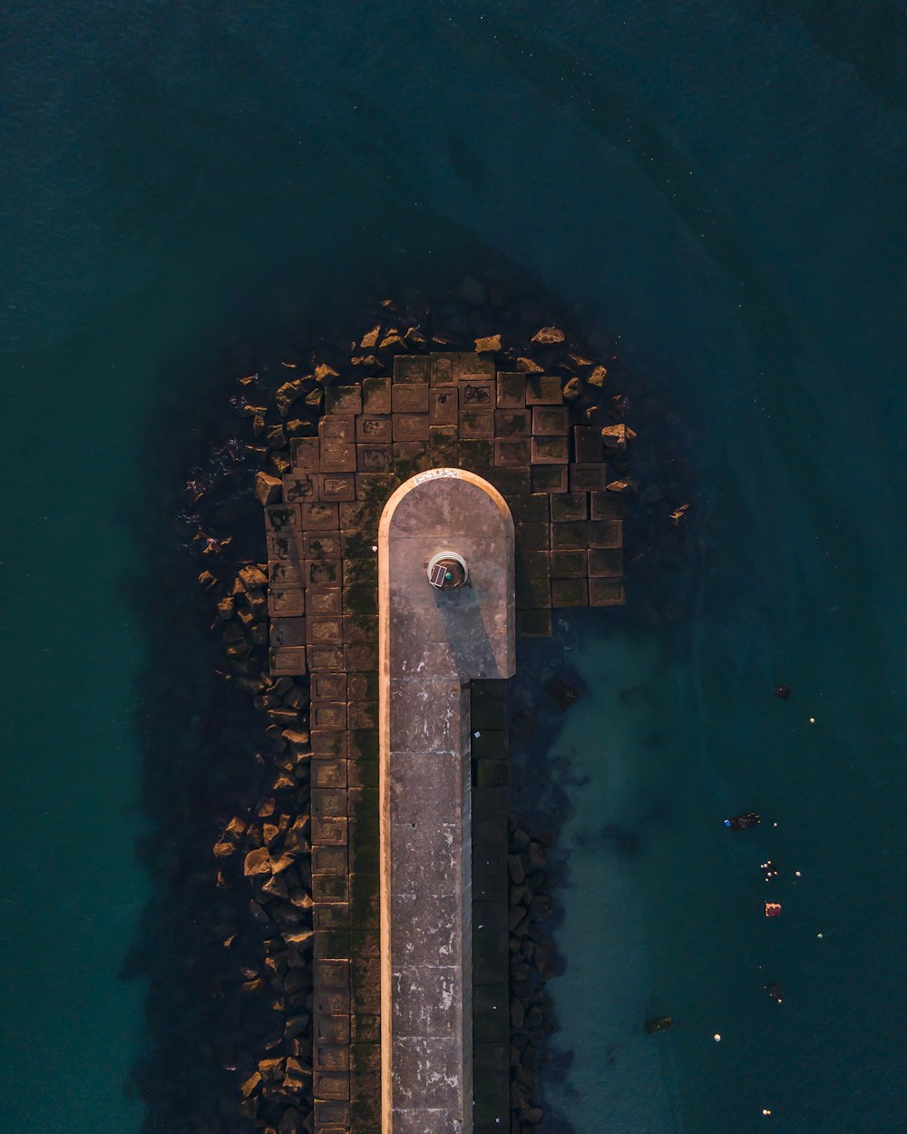 brown concrete pathway on body of water