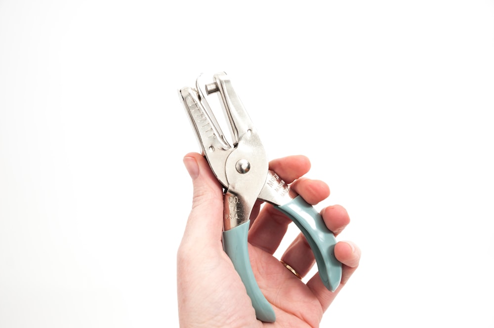 person holding gray cutting tools