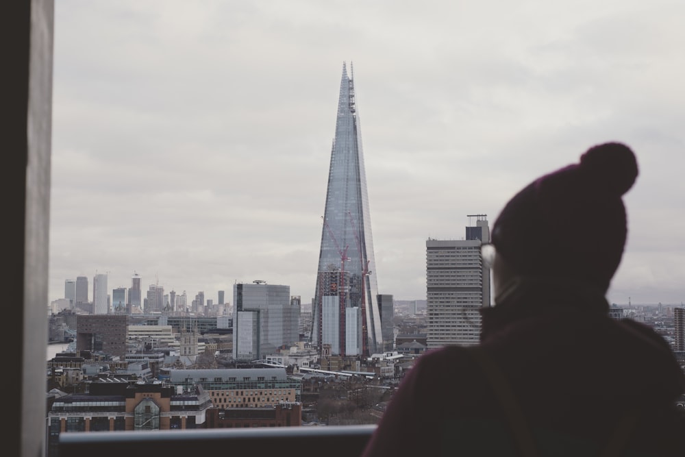 person beside clear glass window