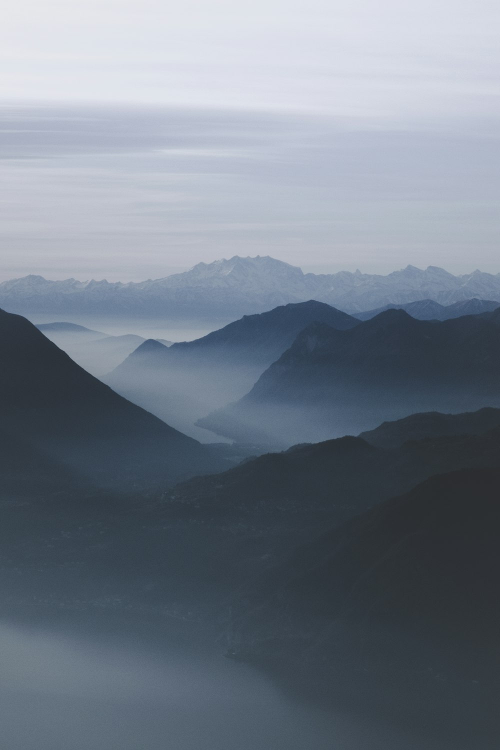 mist mountain range under white sky