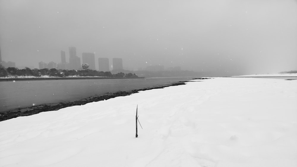 snow covered ground near body of water