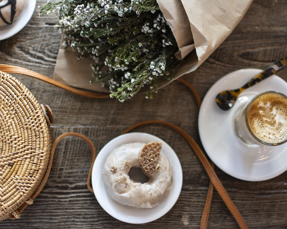 top-view angle photography of doughnut on saucer plate and cup of coffee