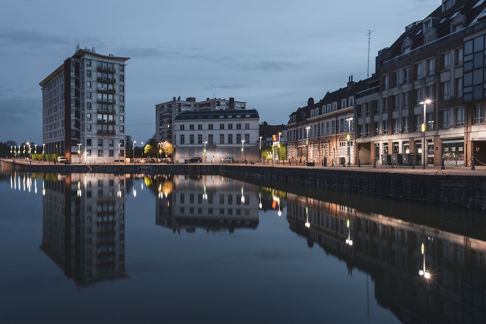 concrete buildings near body of water