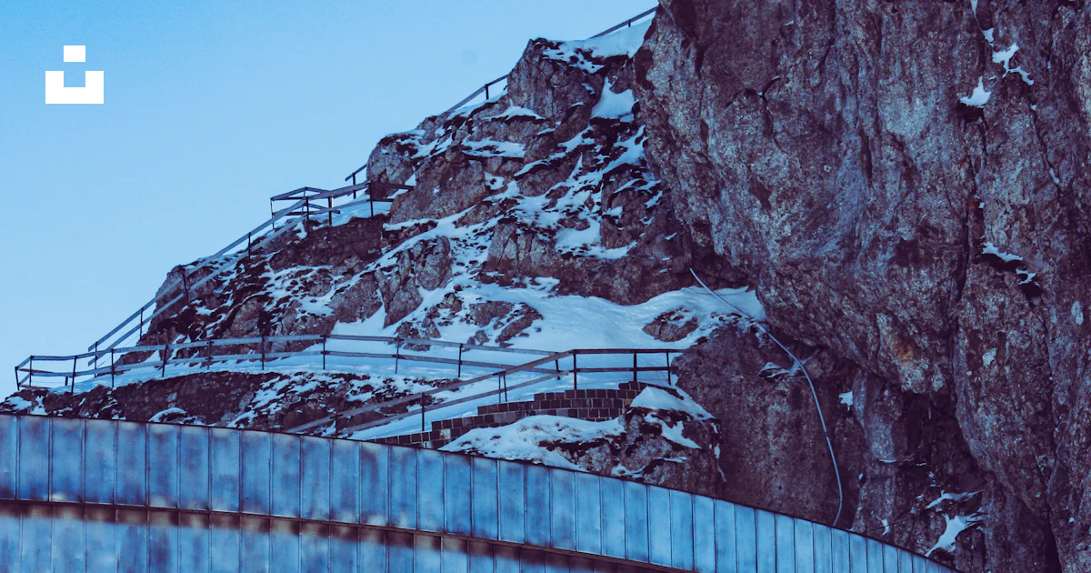 Concrete building beside rock photo – Free Blue Image on Unsplash
