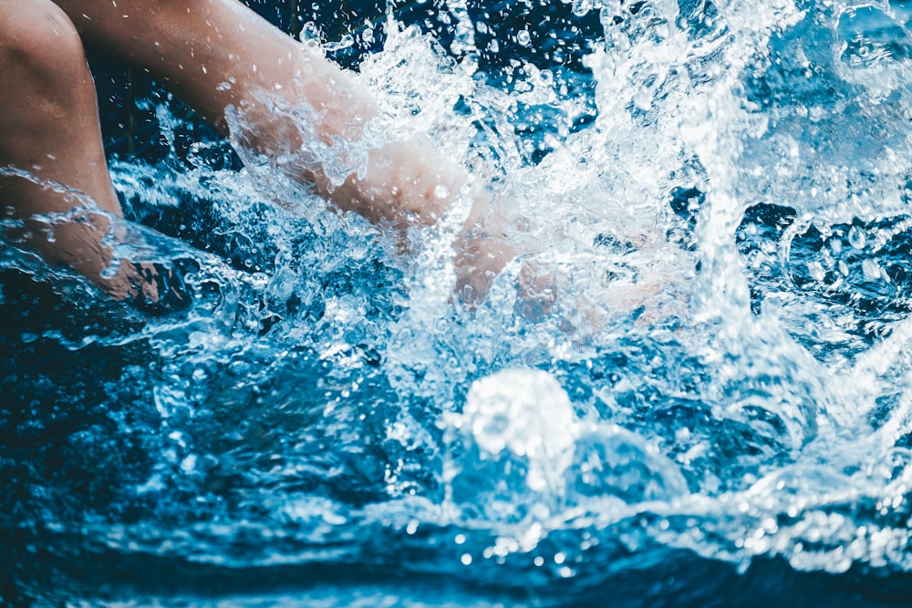 person splashing body of water