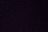 a night sky with a few stars in it