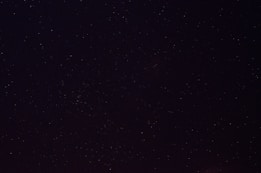 a night sky with a few stars in it