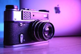 A dynamic shot of a film camera and a laptop side by side, symbolizing the fusion of cinema and digital media.