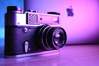 A dynamic shot of a film camera and a laptop side by side, symbolizing the fusion of cinema and digital media.
