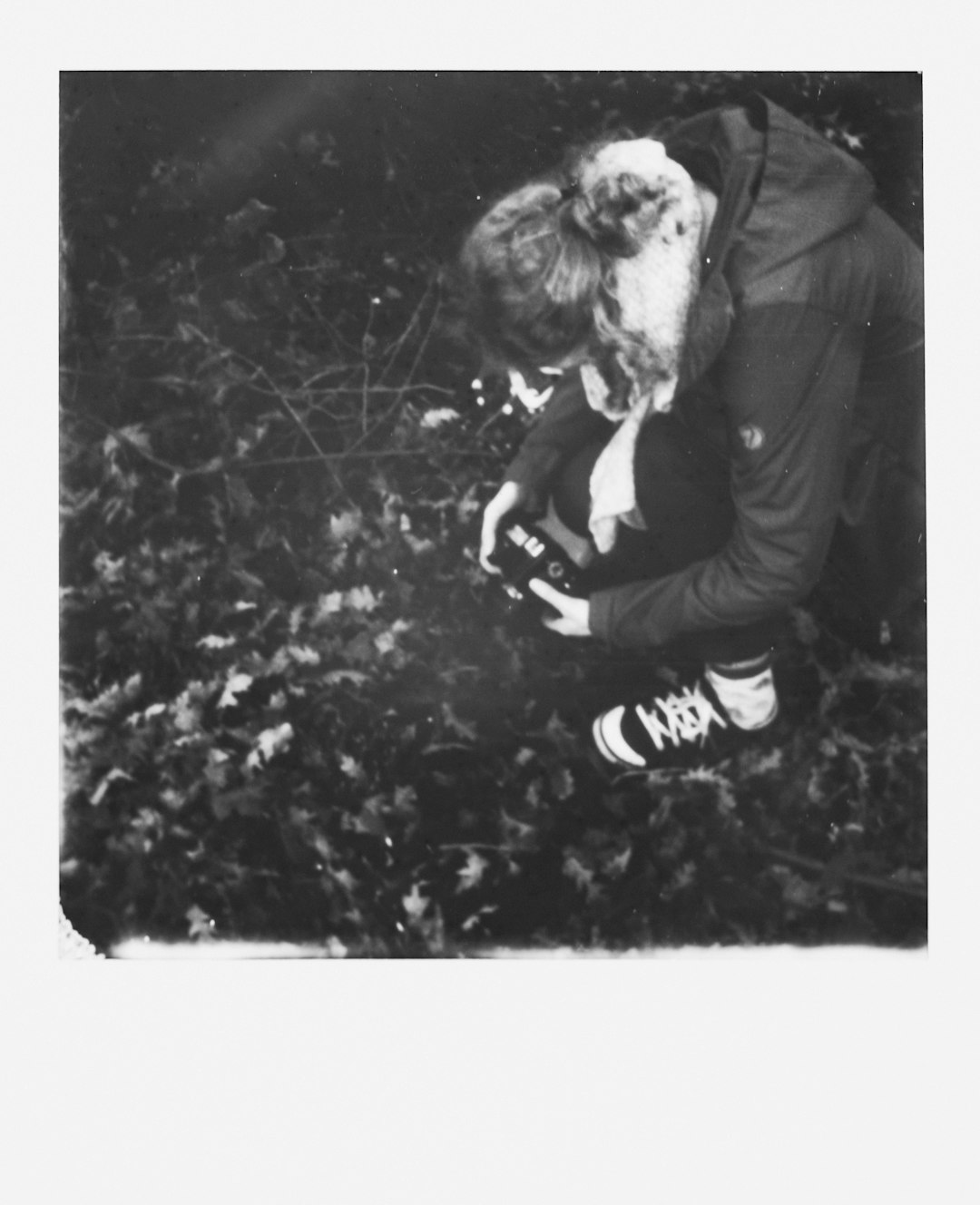 grayscale photography of woman holding camera