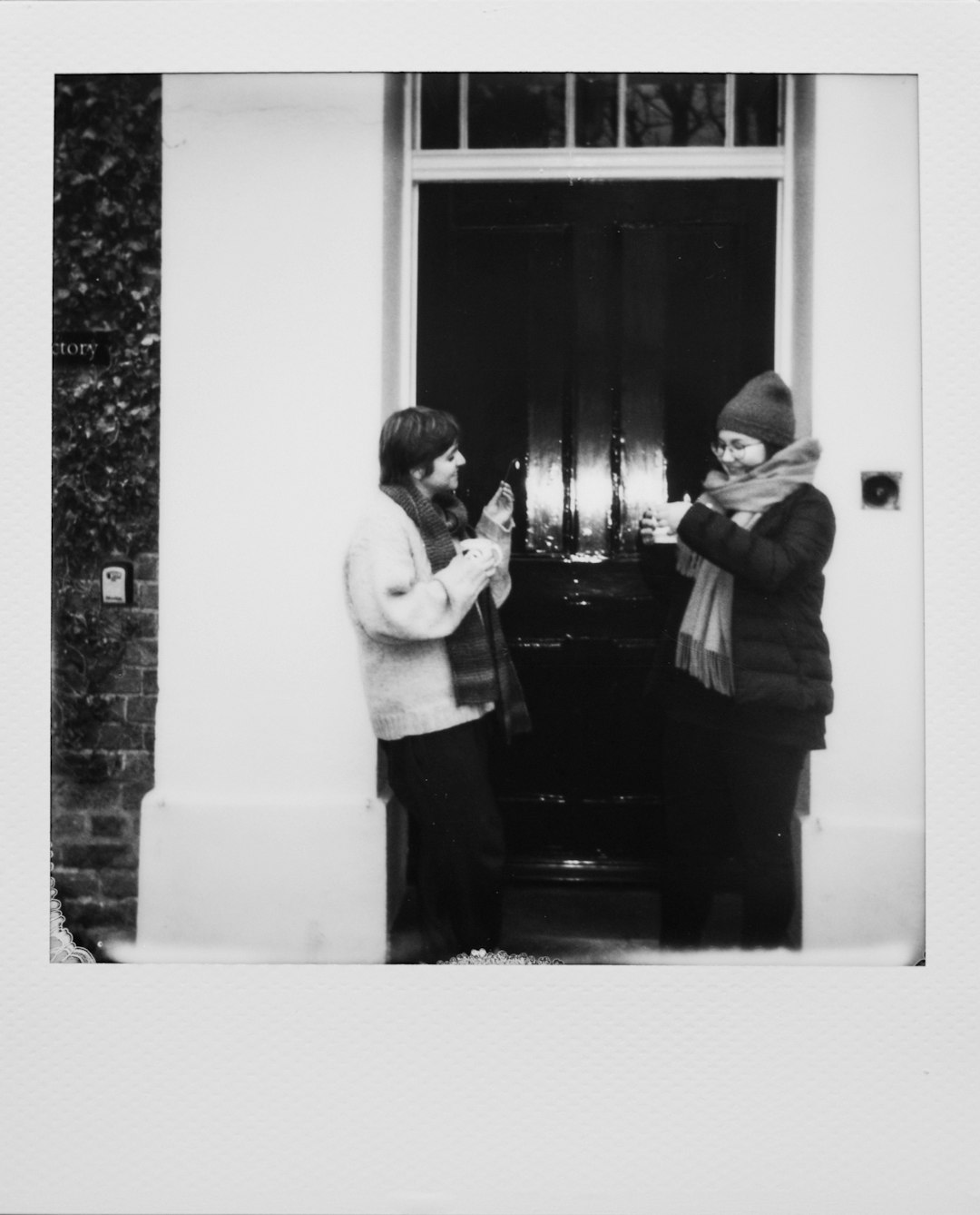 man and woman standing in front of mirror