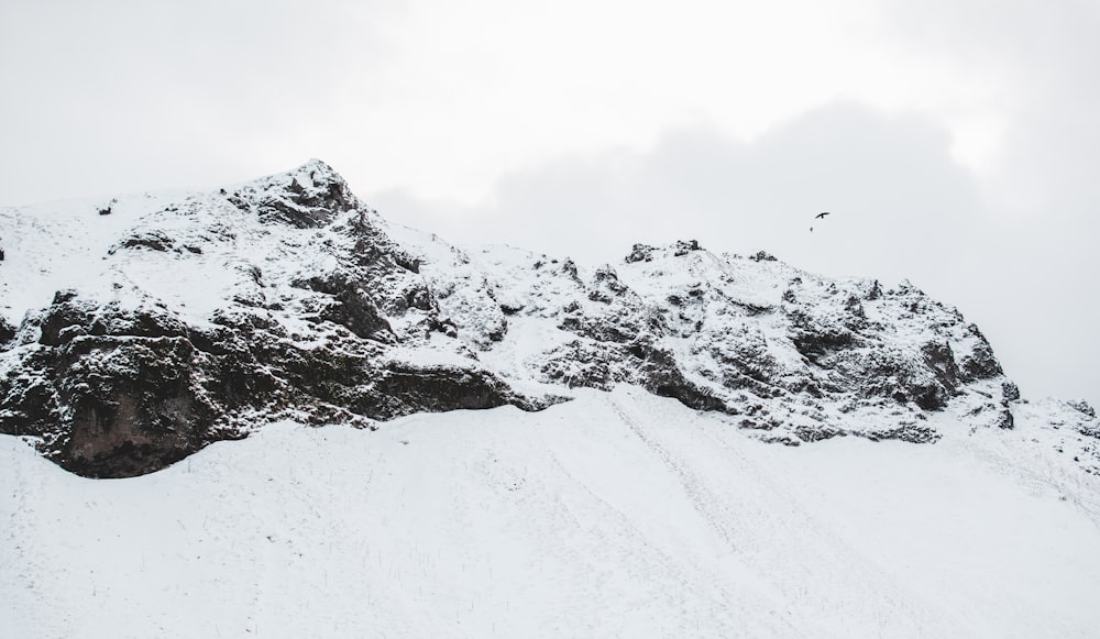 snow covered rocks during daytime