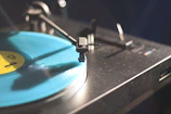 Close-up of a vinyl record spinning on a turntable with warm lighting.