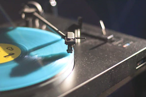 Close-up of a monochrome vinyl record spinning under soft light with subtle blur effects