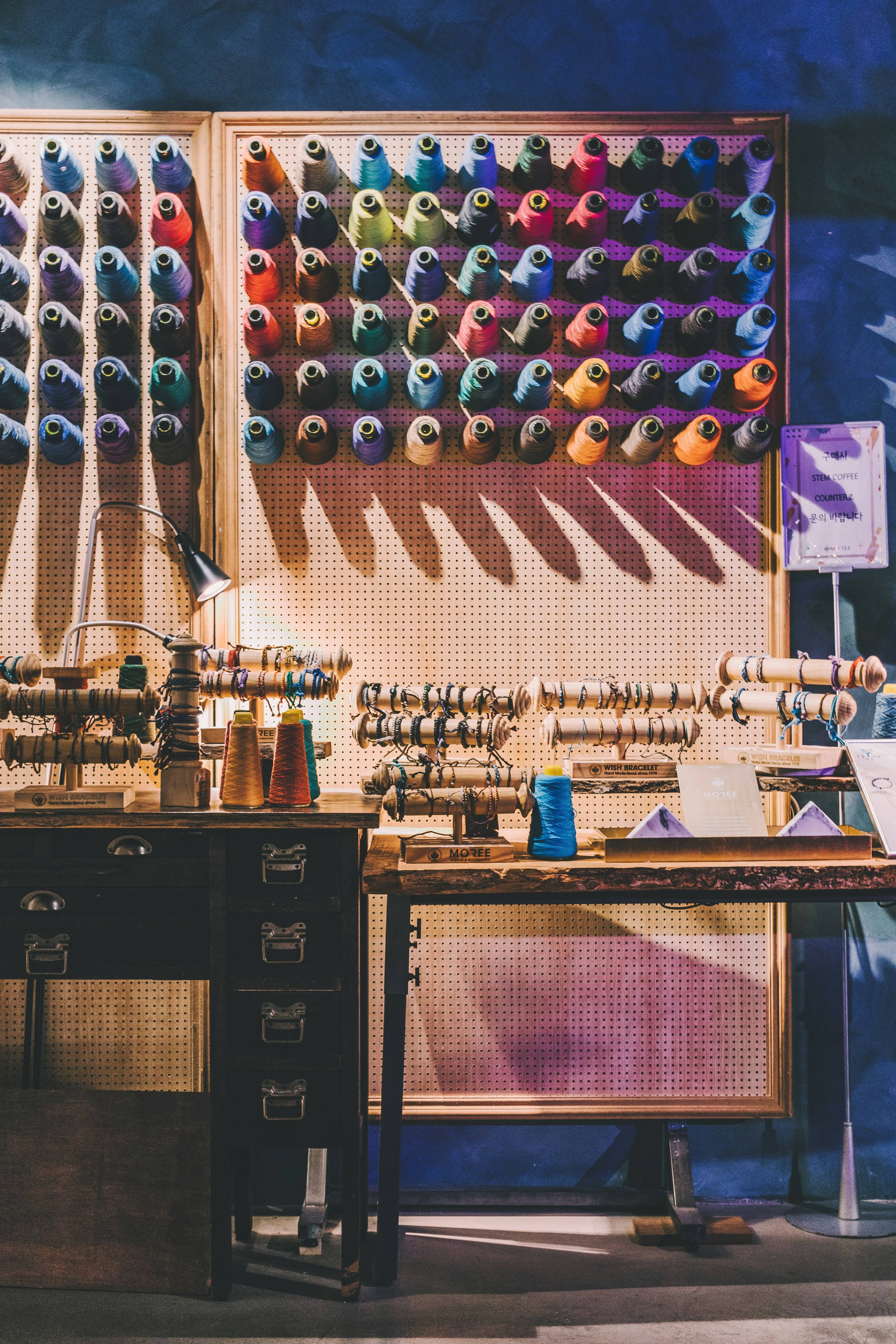 assorted-color sewing threads on organizer rack