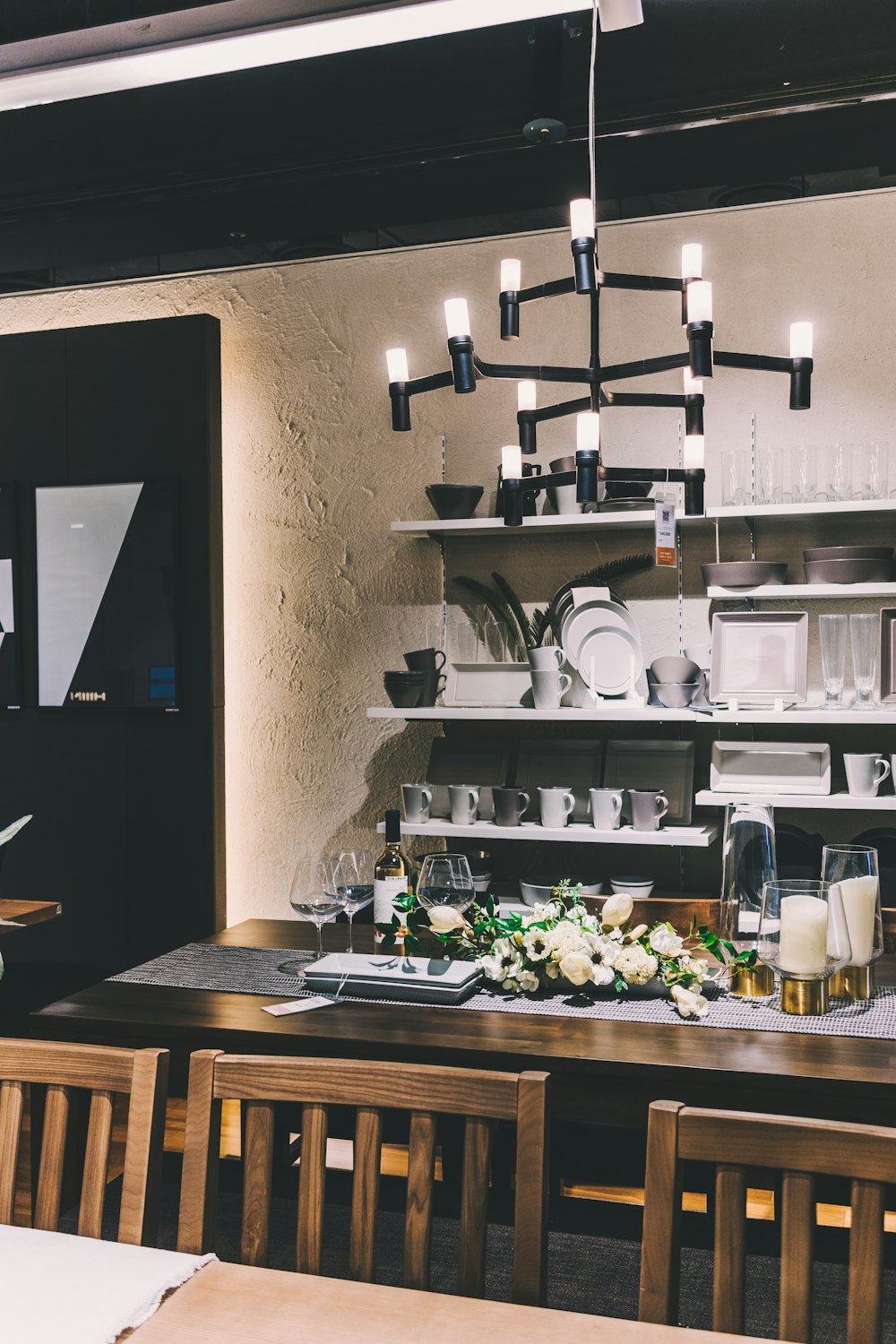 empty dining set under chandelier inside lighted room