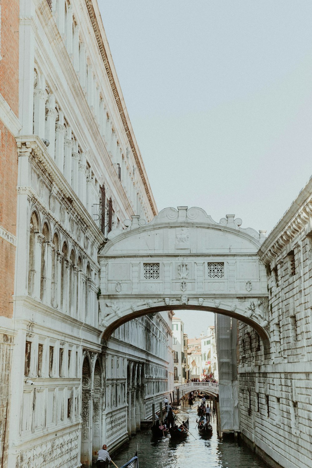 Venice canal between high-rise building