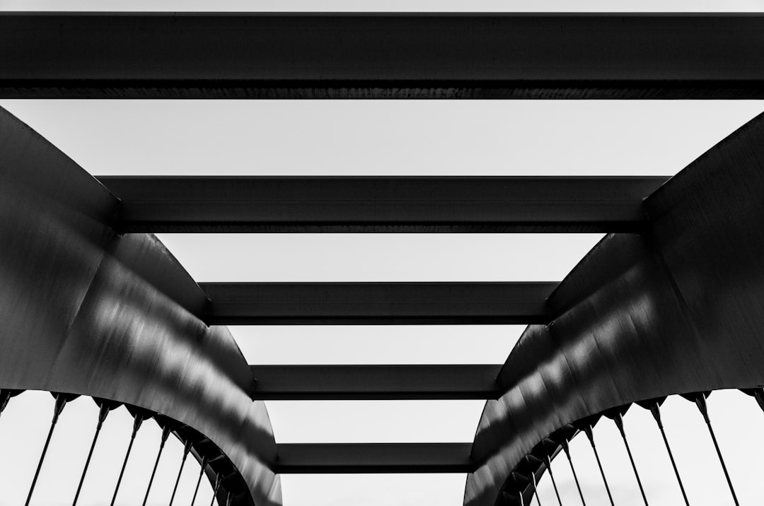 greyscale photo of metal bridge